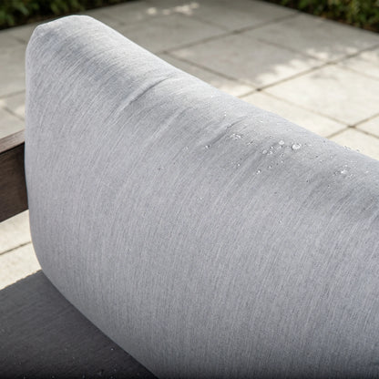 Close-up of water droplets effortlessly sliding off the premium gray Sunbrella back cushion of the outdoor chair.

