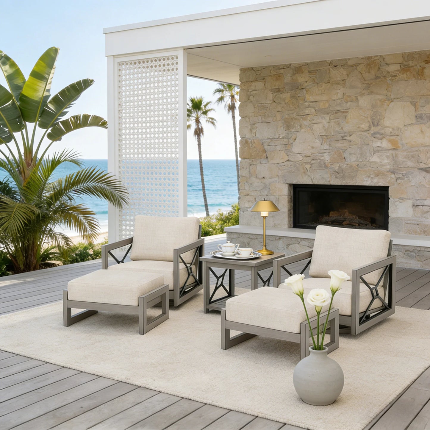Outdoor patio set with swivel chairs, ottoman, and table on a deck with ocean view.