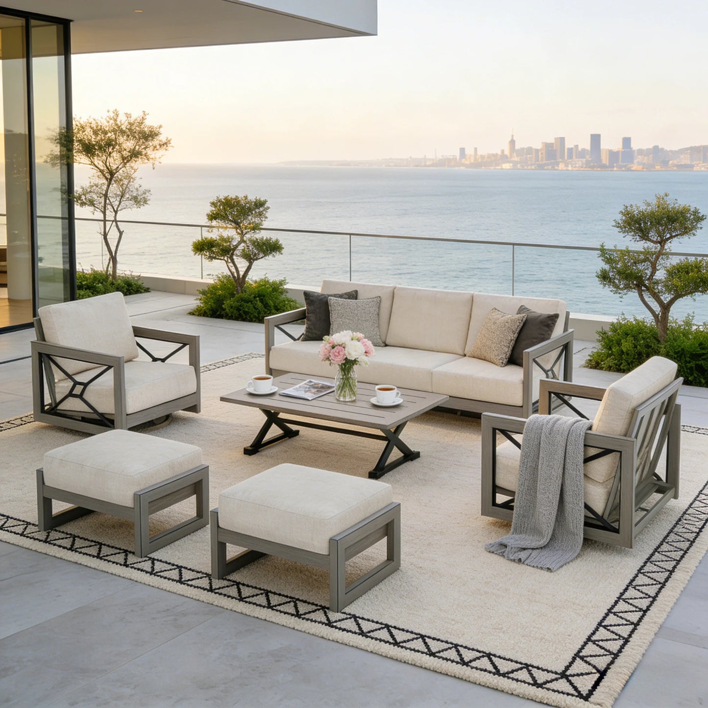 Outdoor patio set with furniture and decor on a balcony with ocean view