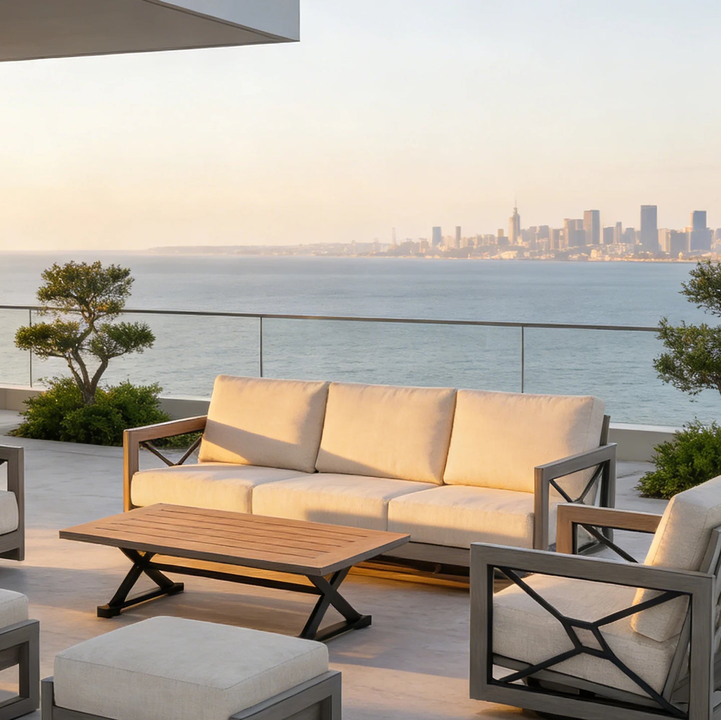 Outdoor patio set with beige cushions and wooden coffee table on a balcony with ocean view.