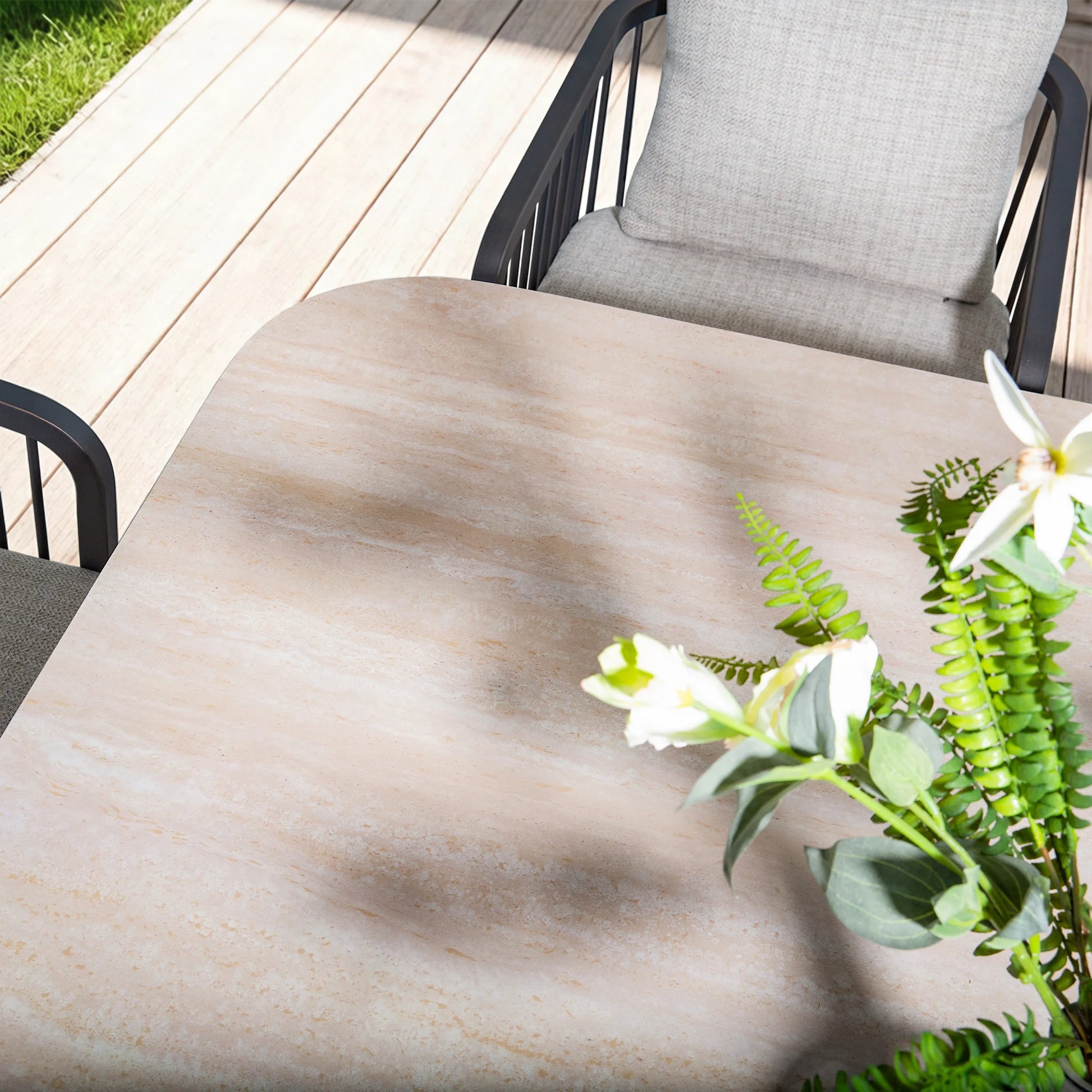 Outdoor table with a floral arrangement on a wooden deck