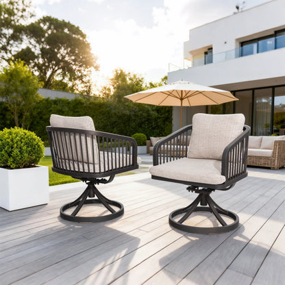 Two outdoor chairs with beige cushions on a wooden deck with a building and trees in the background.