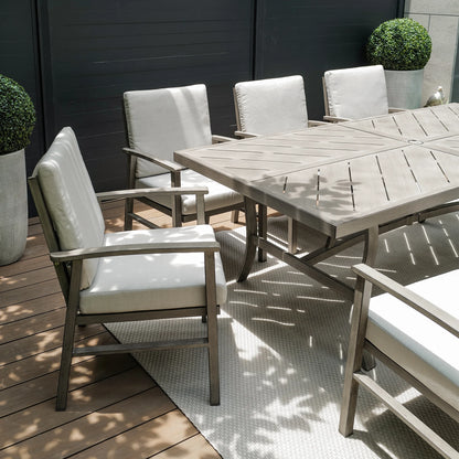 Outdoor dining set with wooden table and chairs on a deck