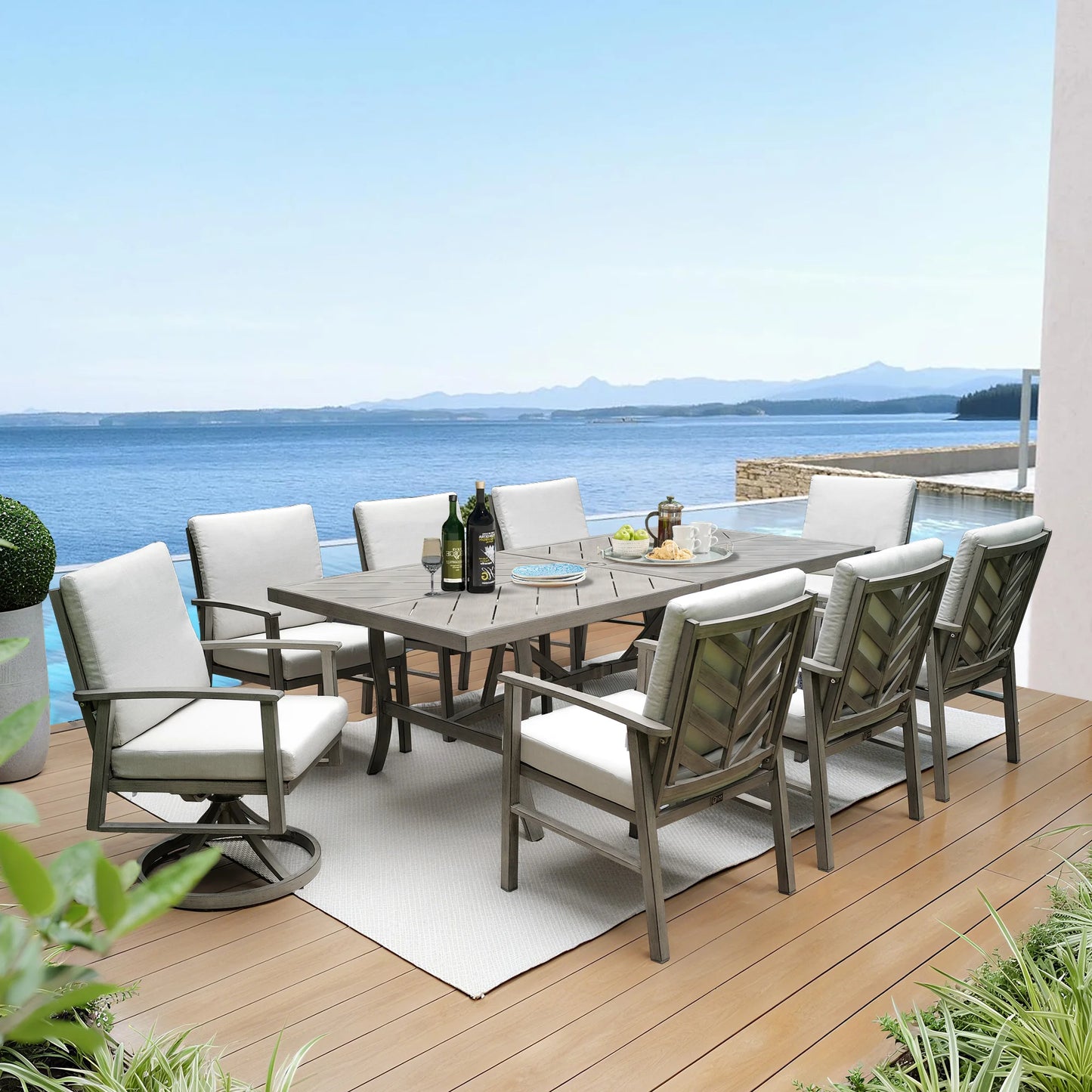 Outdoor dining set with chairs and table on a deck overlooking water