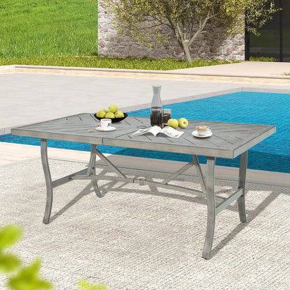 Outdoor dining table with fruit and glasses by a poolside