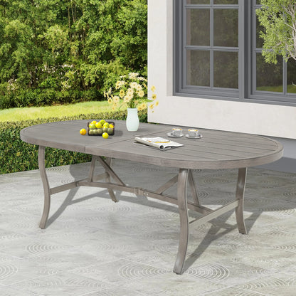 Oval outdoor dining table with fruit and a vase on a patio