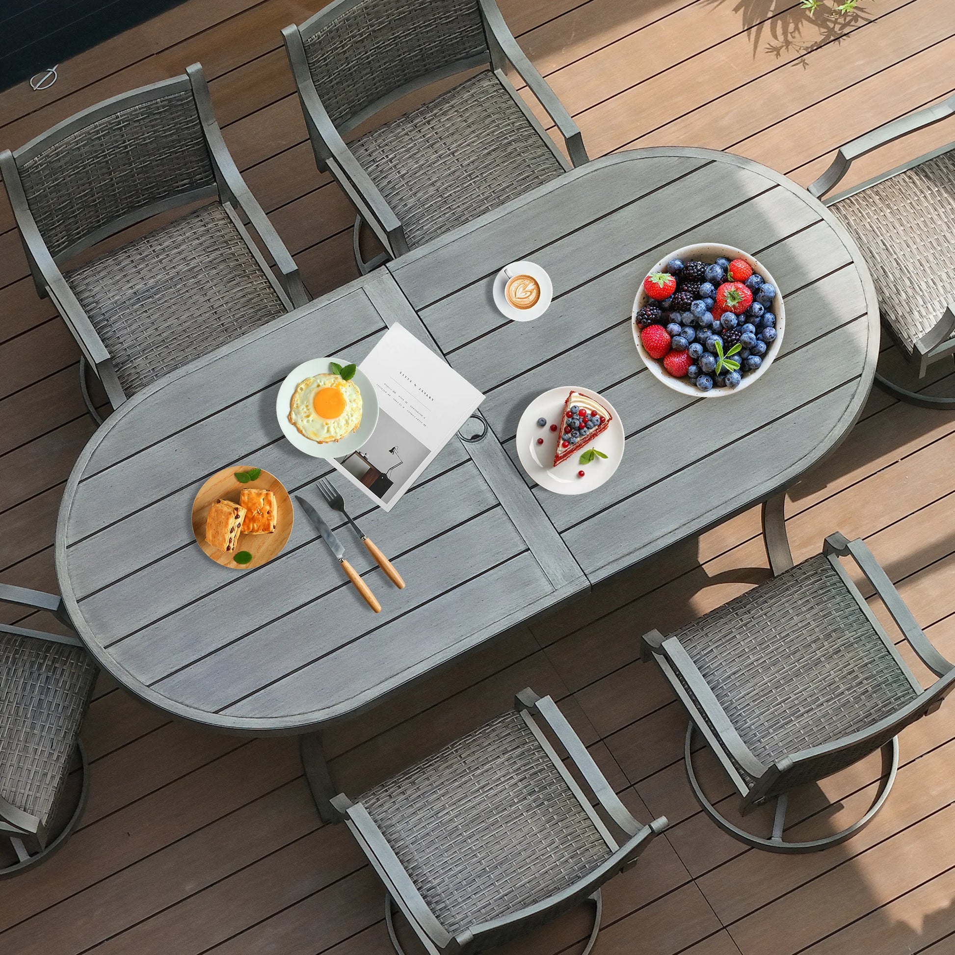 Outdoor dining setup with a gray table and chairs on a wooden deck.