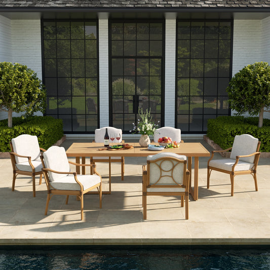 Outdoor dining set with wooden table and chairs on a patio by a pool