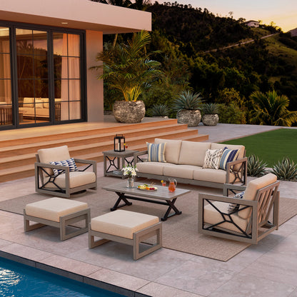 Outdoor patio set with furniture and decor by a poolside.