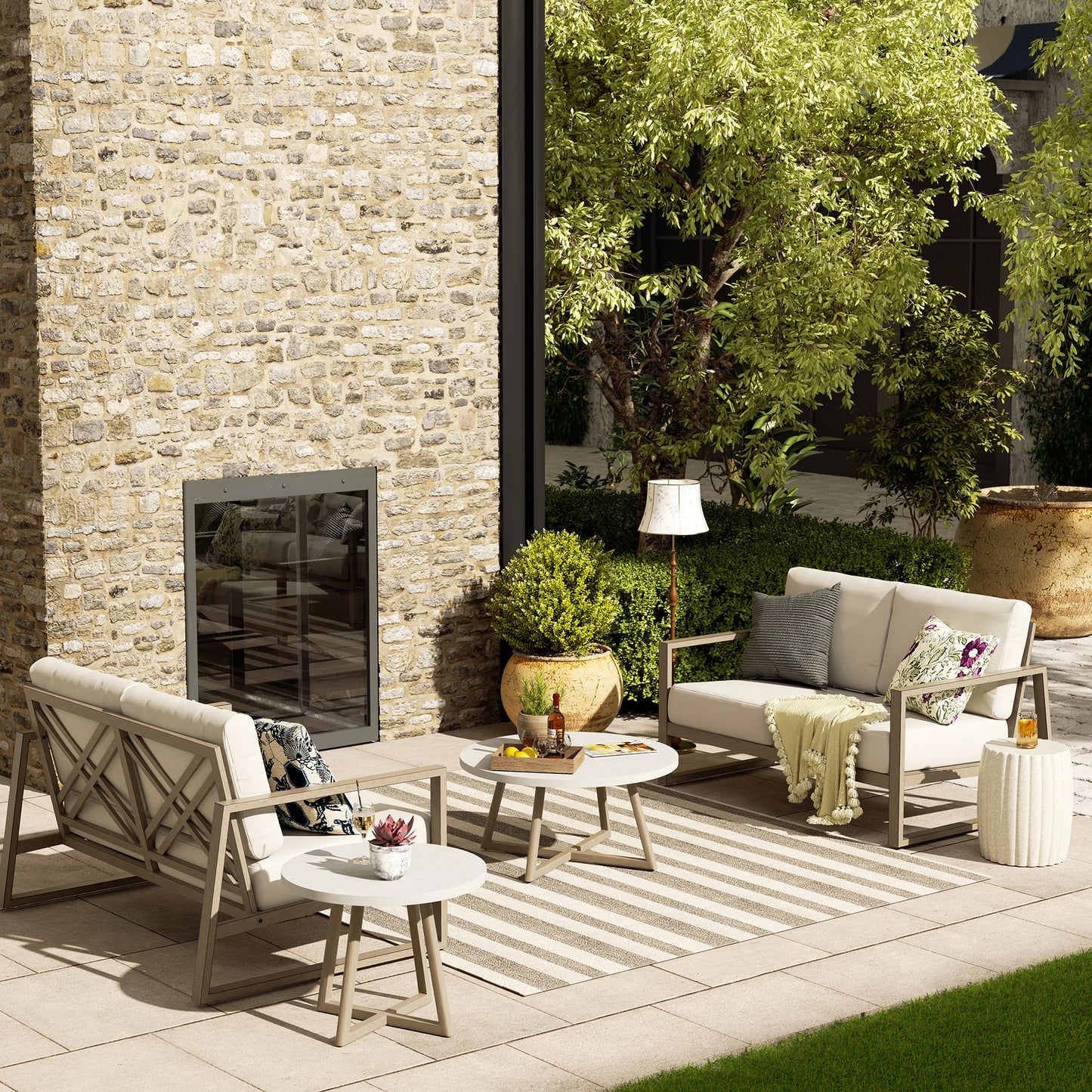 Outdoor patio with stone wall, furniture, and decorative elements