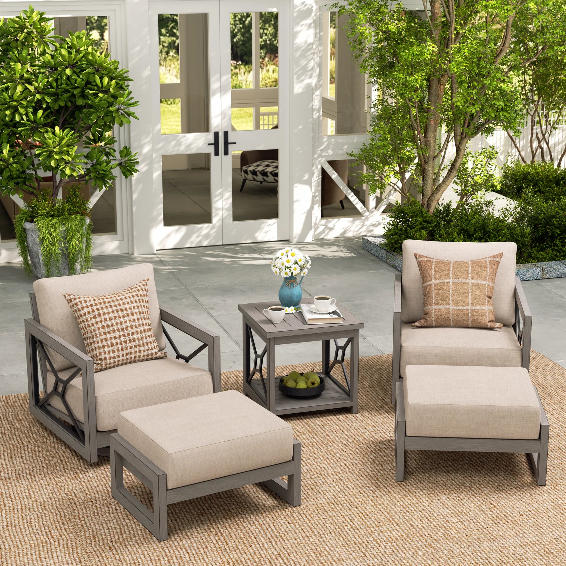 Outdoor patio set with chairs, ottoman, and table near a pool