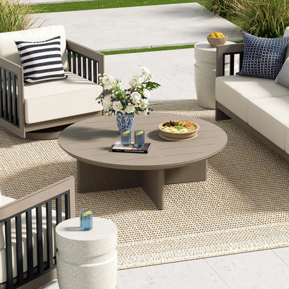 Outdoor patio setting with furniture, table, and decorative items on a patio.
