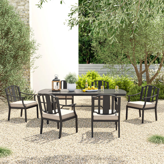 Outdoor patio set with table and chairs in a garden setting