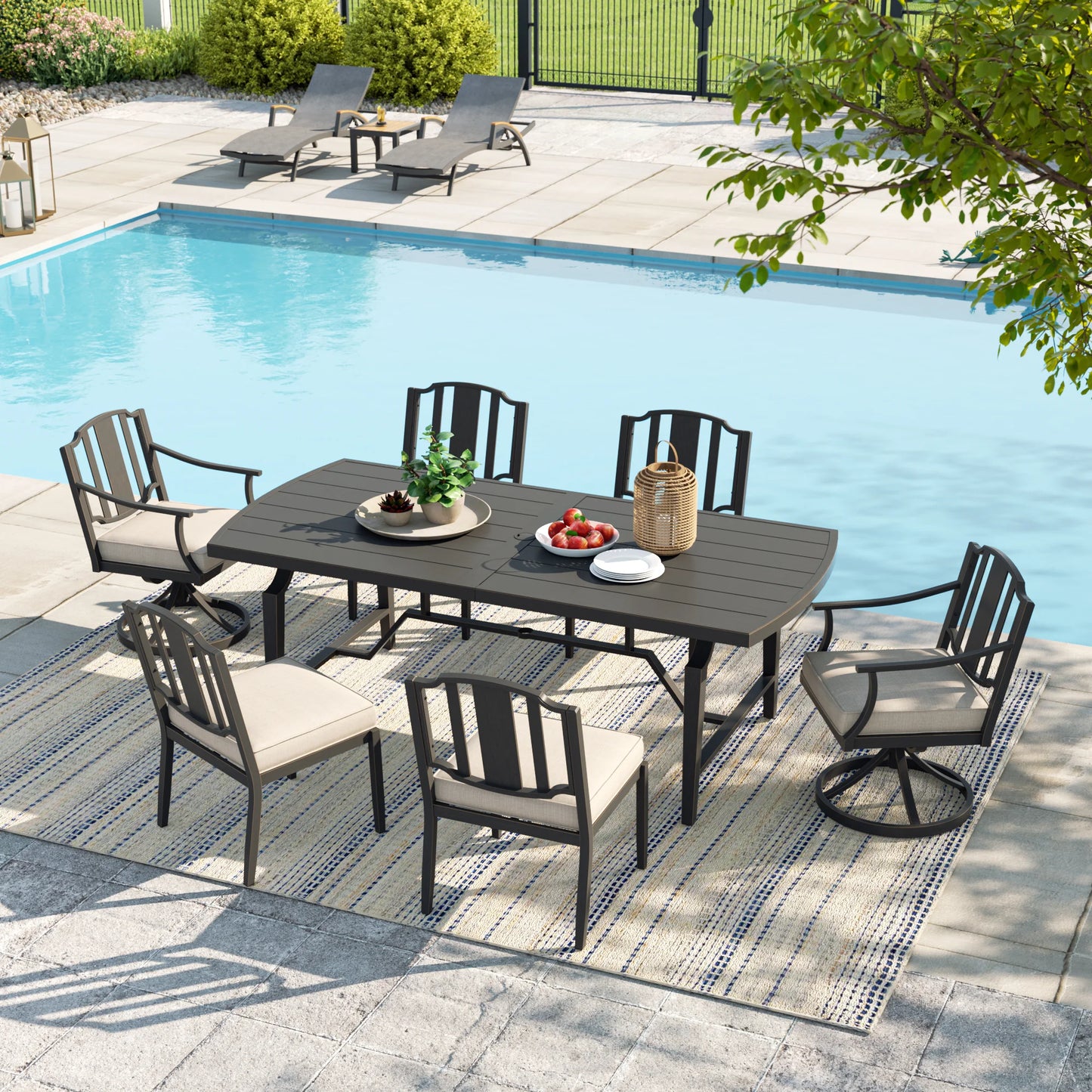 Outdoor patio set with table and chairs by a pool