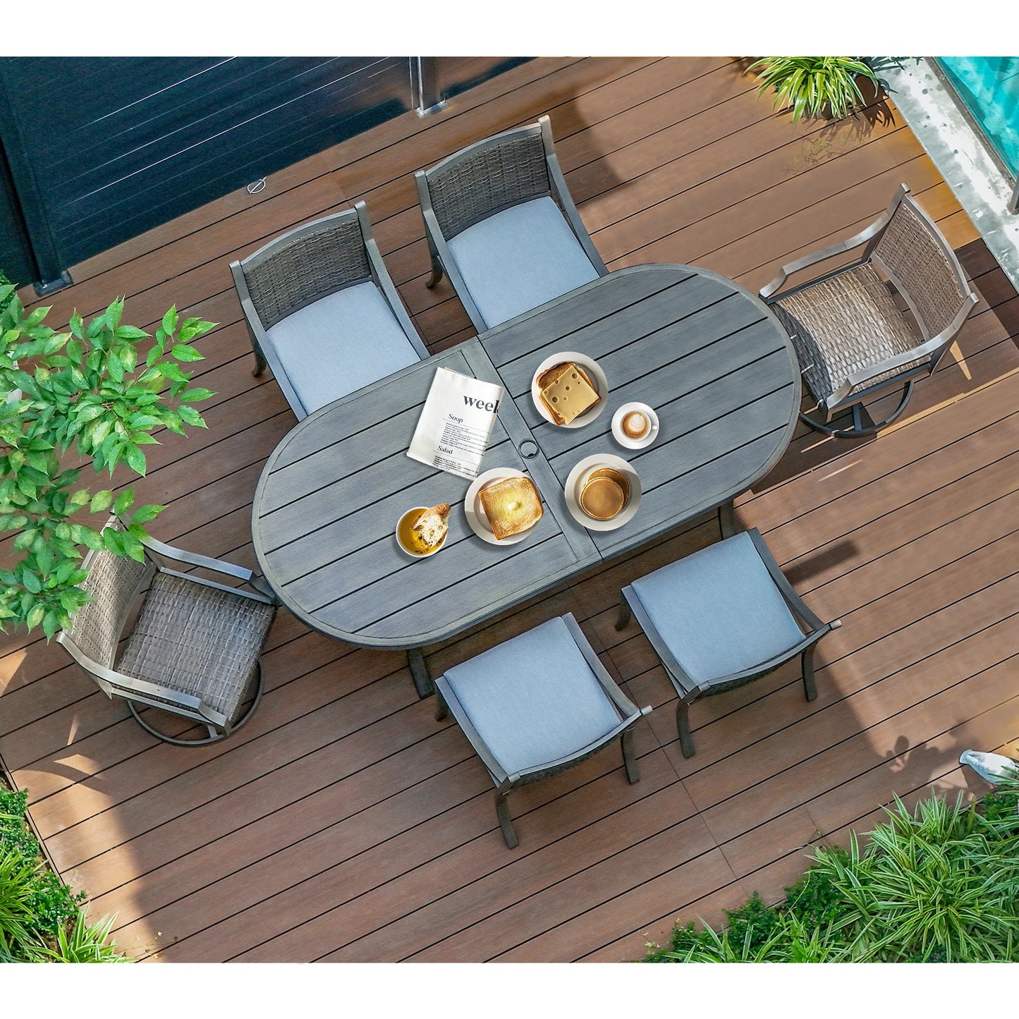 Outdoor dining set with a table and chairs on a wooden deck.