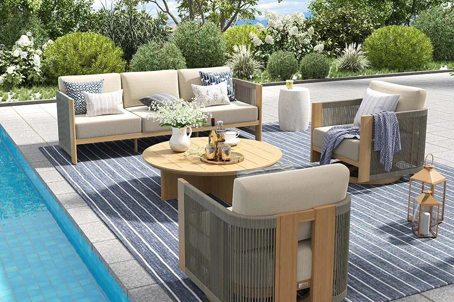 Outdoor patio set with furniture and decor by a pool
