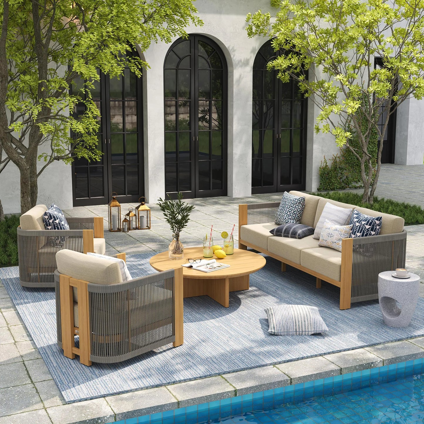 Outdoor patio set with furniture and decor by a poolside.