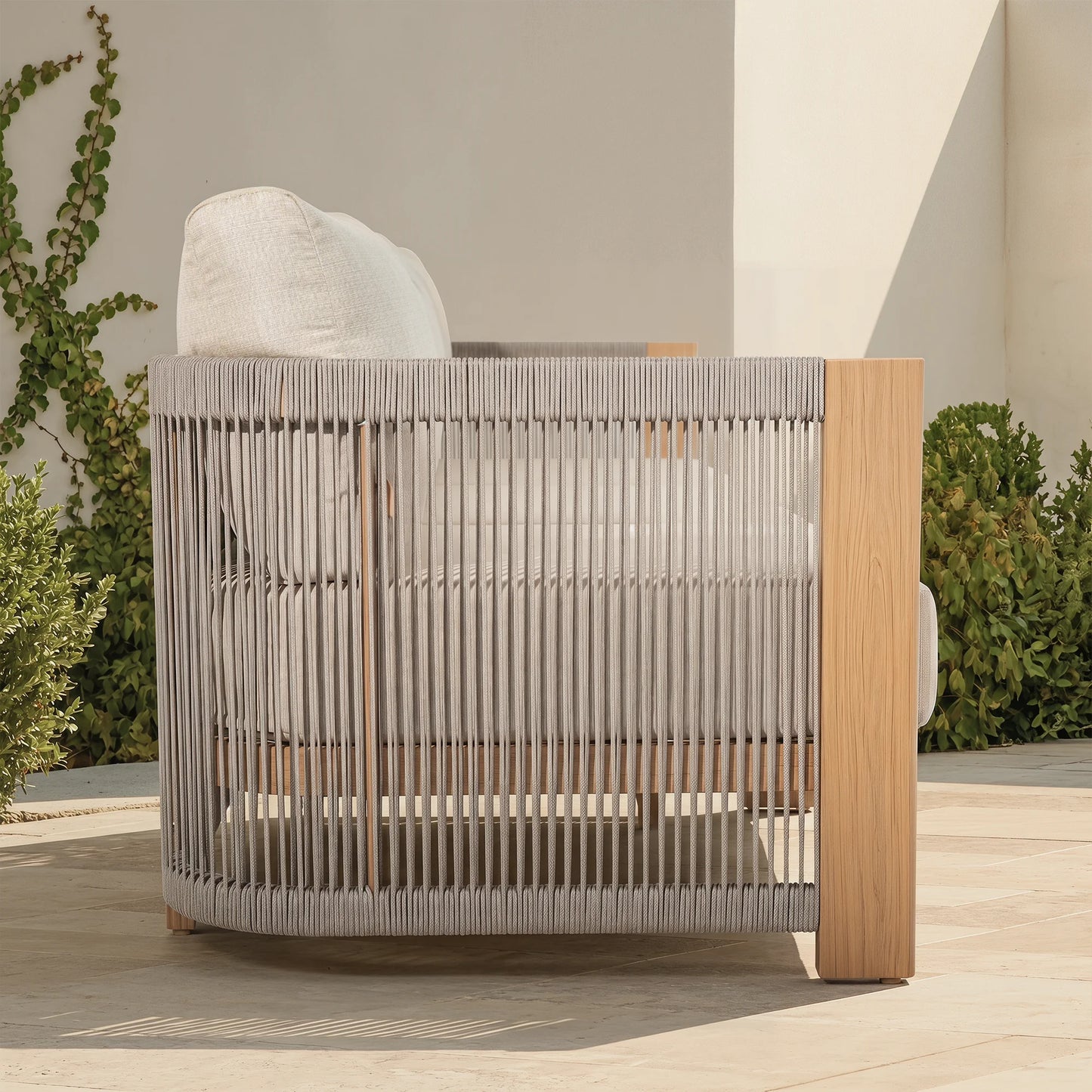 Modern outdoor chair with wood-look frame and woven backrest on a patio