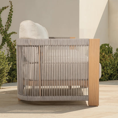 Modern outdoor chair with wood-look frame and woven backrest on a patio