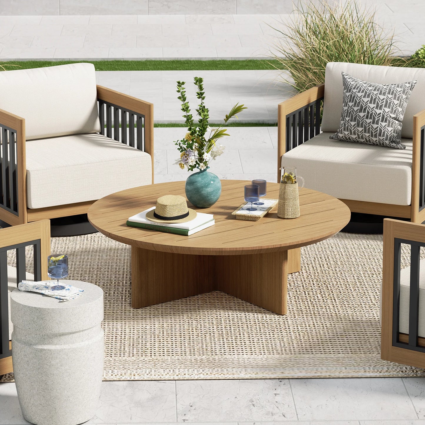 Outdoor patio set with round table and chairs on a patio.