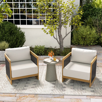 Outdoor patio set with two chairs and a small table on a stone patio.