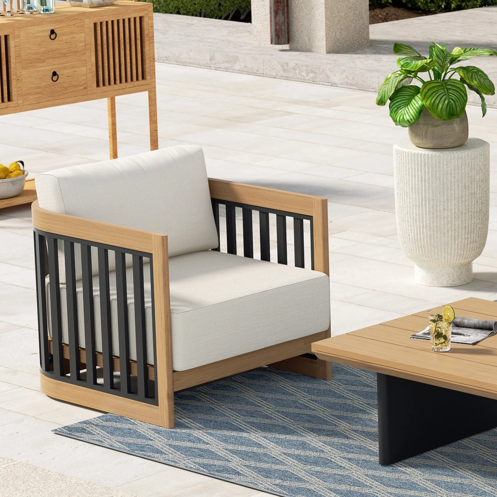 Outdoor patio set with wooden chair, table, and plant on a patio.