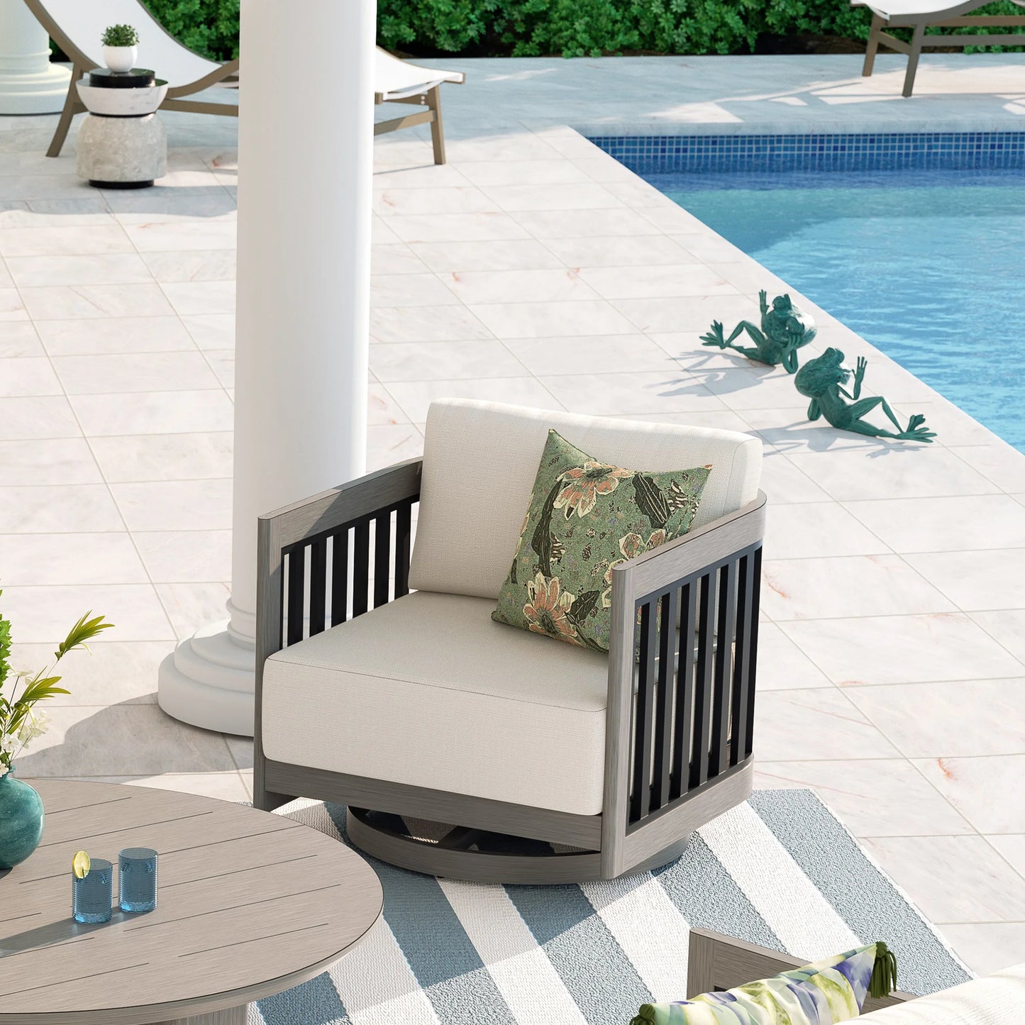 Outdoor chair with beige cushions and a floral pillow by a poolside.