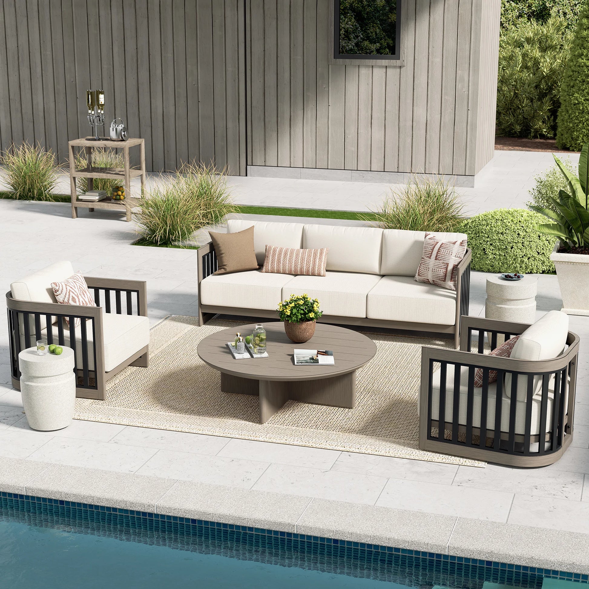 Outdoor patio set with furniture and decor by a pool