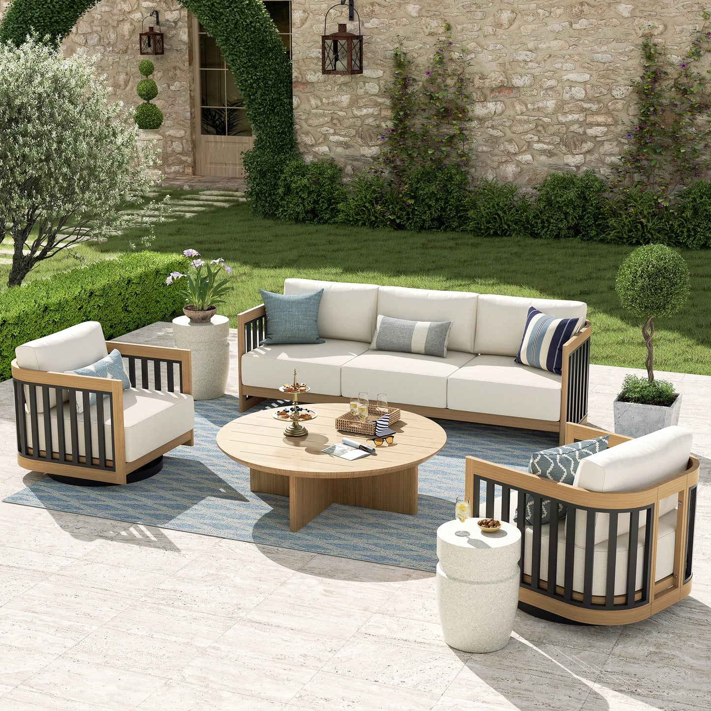 Outdoor patio furniture set with a stone wall and garden in the background