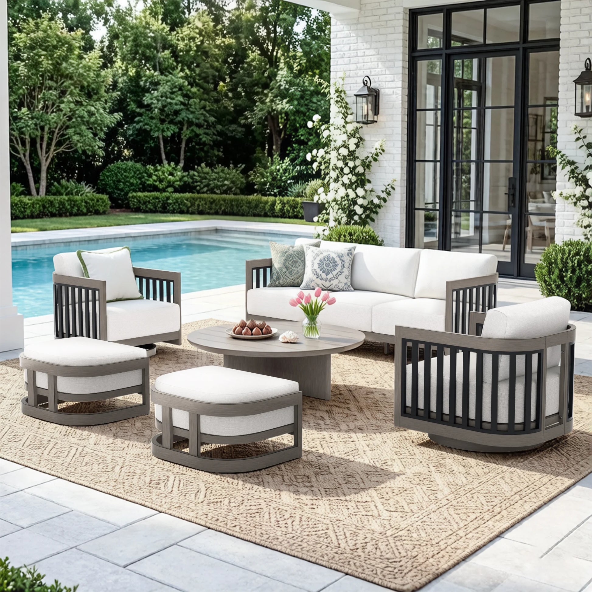 A 6-piece outdoor patio conversation set with a sofa, two armchairs, two ottomans, and a round coffee table, arranged on a patterned rug next to a swimming pool in a modern backyard setting.