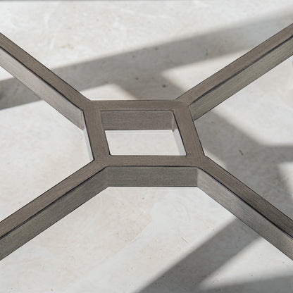 Close-up of a metal geometric floor design on a light stone floor.
