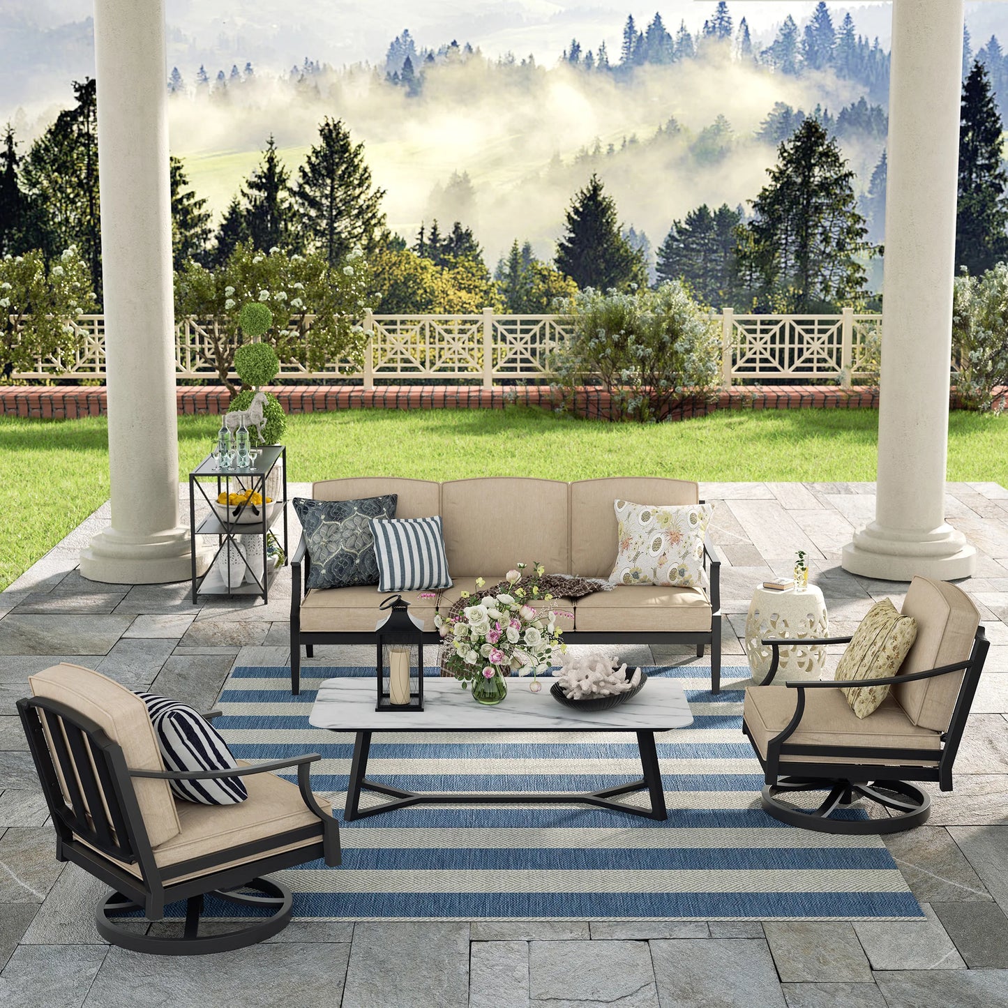 Outdoor patio set with furniture and decor on a stone patio with a scenic background.