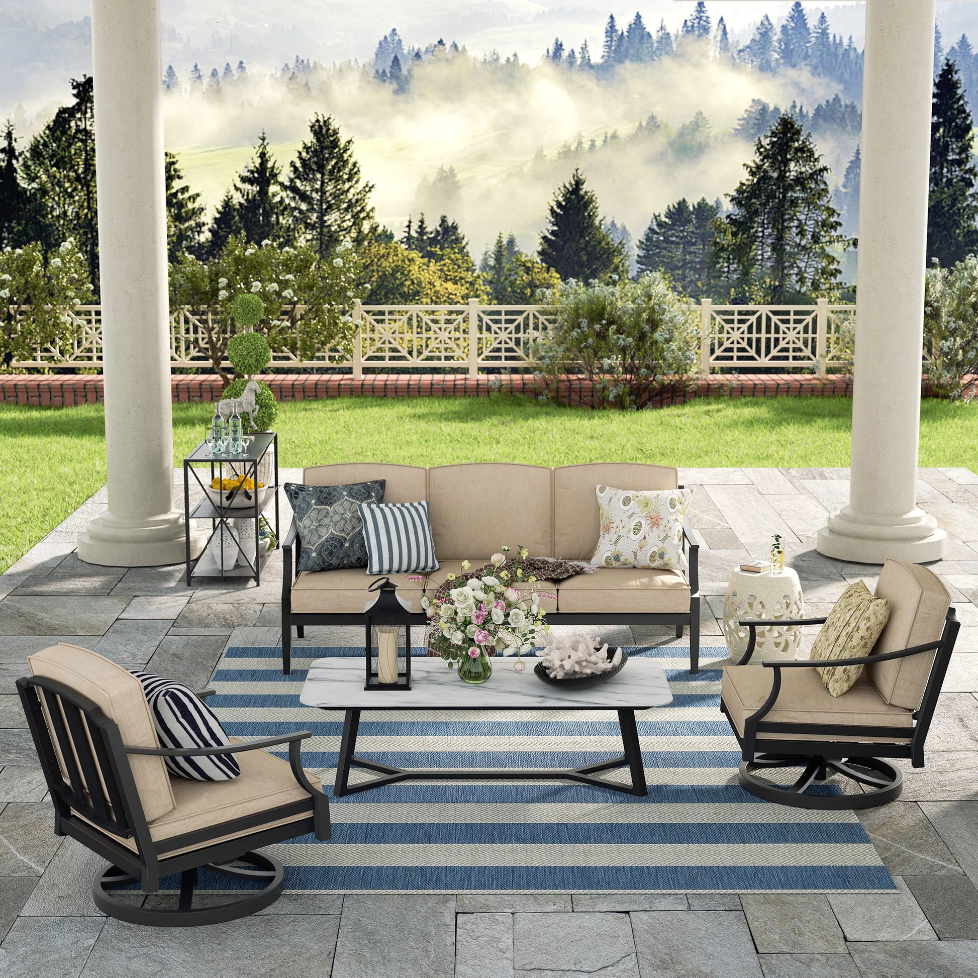 Outdoor patio set with furniture and decor on a stone patio with a scenic background.