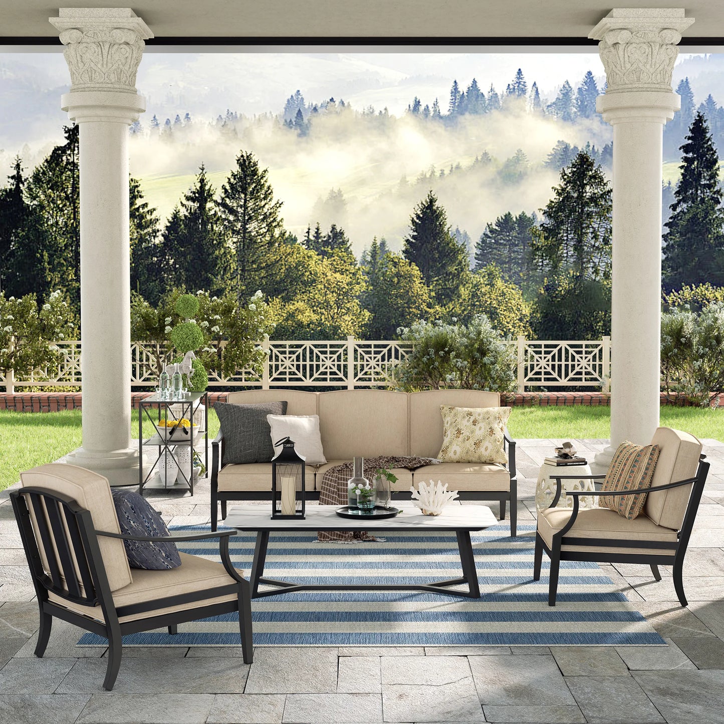 Outdoor patio set with furniture and decor on a stone patio with a scenic background.