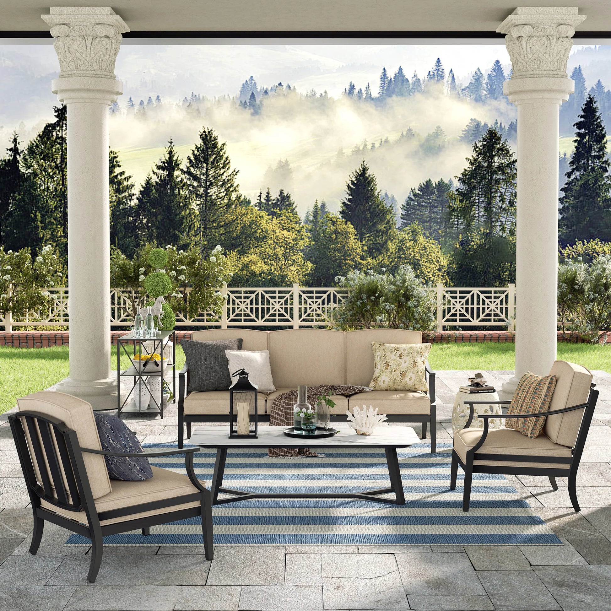 Outdoor patio set with furniture and decor on a stone patio with a scenic background.
