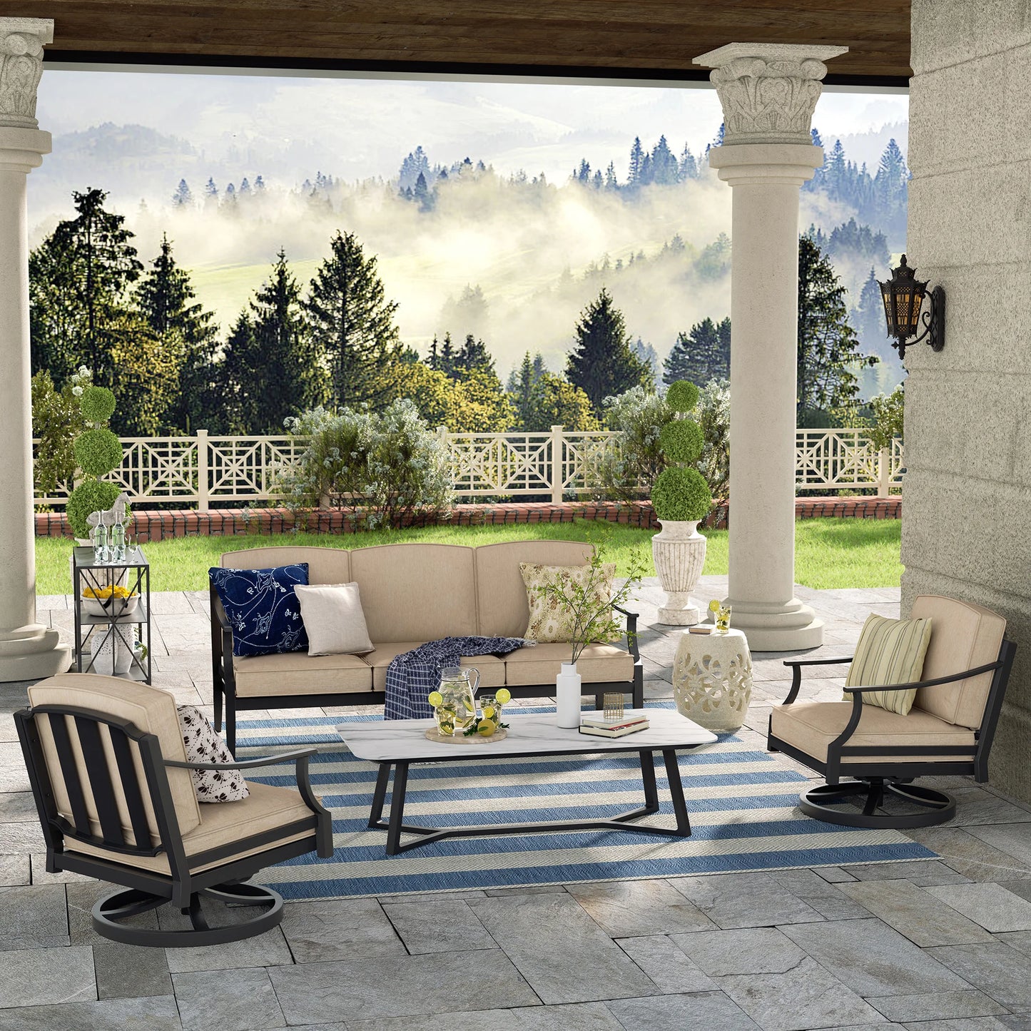 Outdoor patio with furniture and a scenic view of trees and a house.
