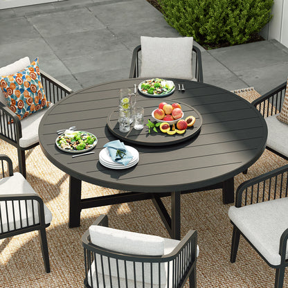 Round outdoor dining table with chairs and food on a patio