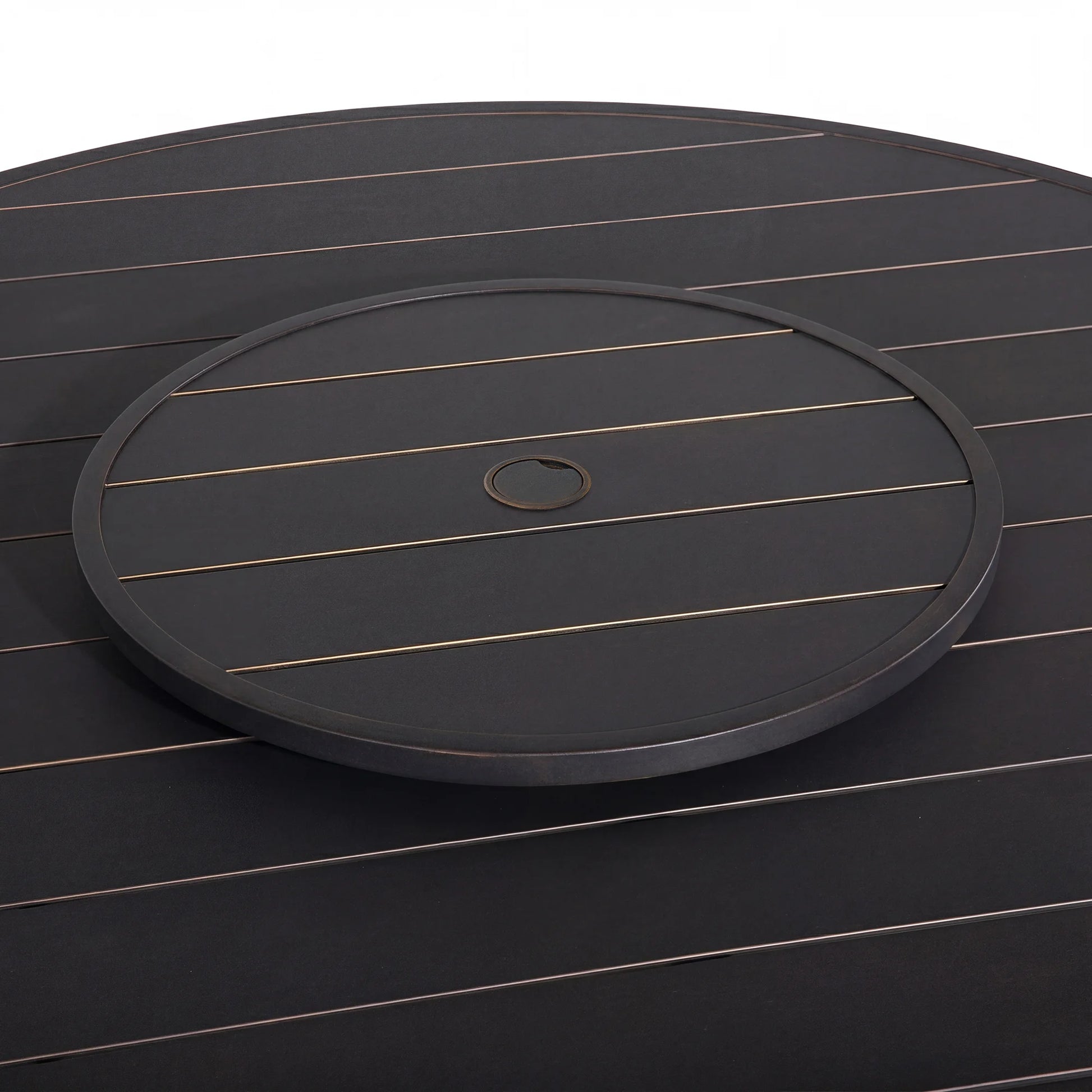 Round black tray with a central hole on a matching dark surface