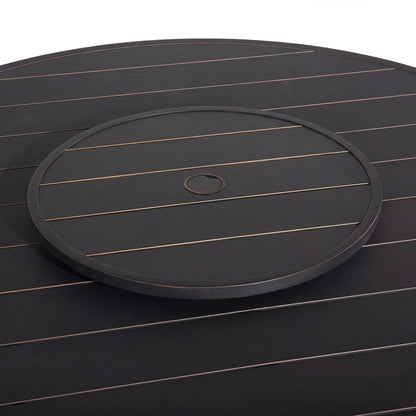 Round black tray with a central hole on a matching dark surface