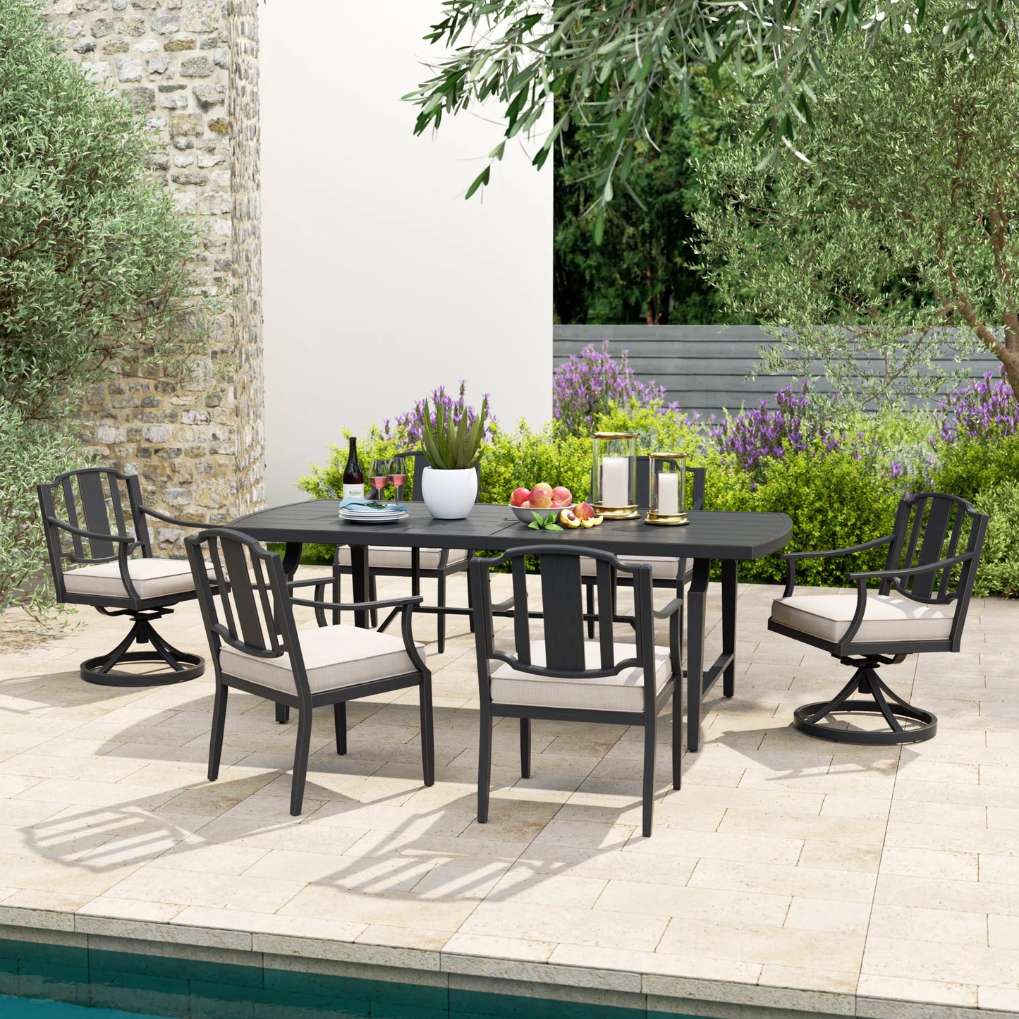 Outdoor patio set with table and chairs on a patio area near a pool.
