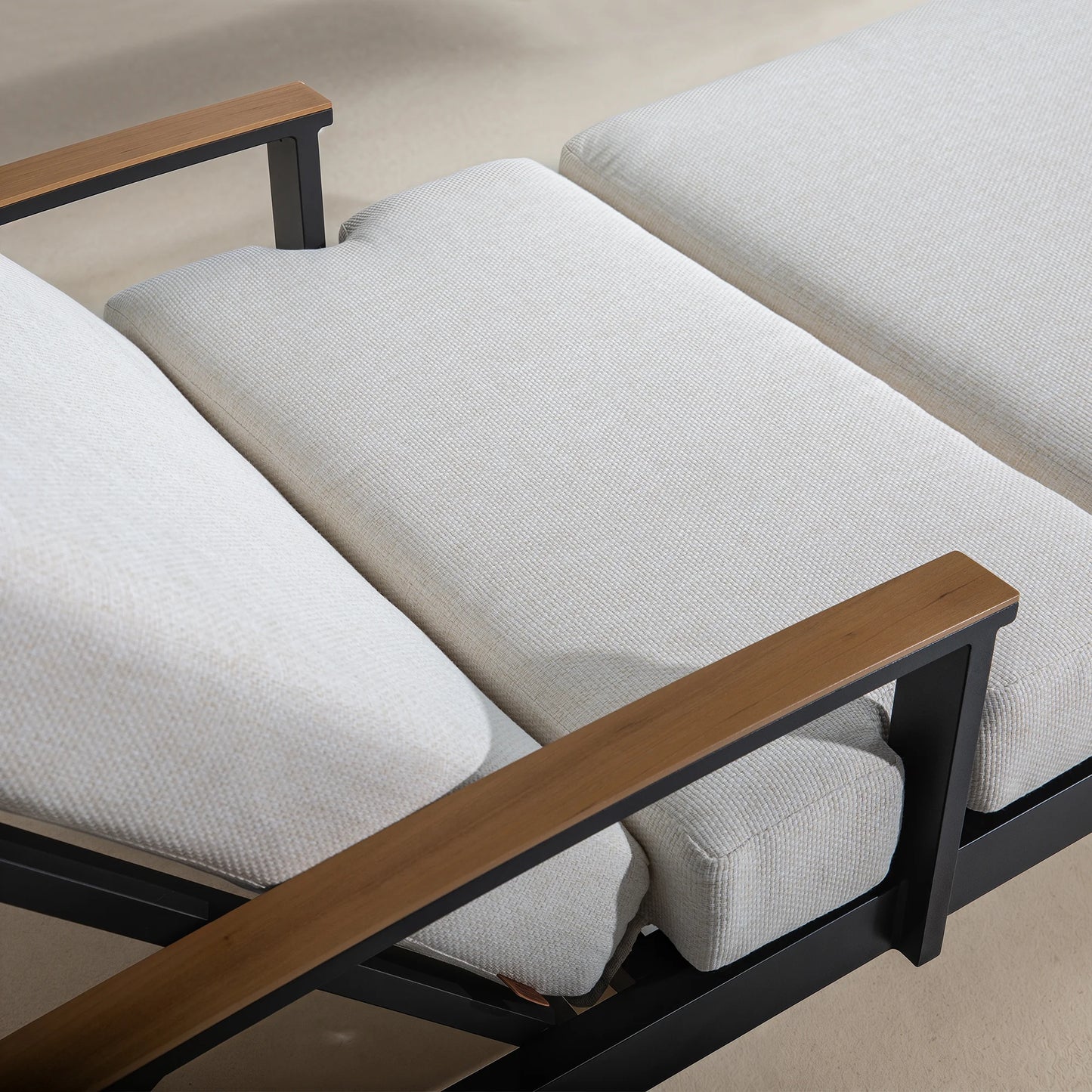 Sofa with wooden armrests and black frames on a beige background