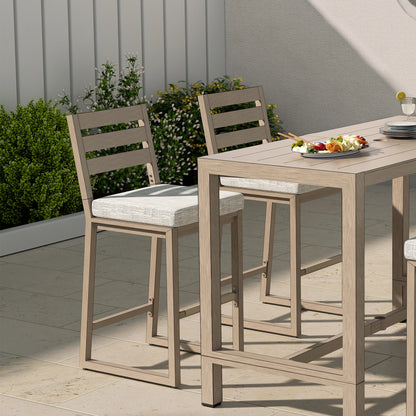 Outdoor dining set with wooden table and chairs on a patio.