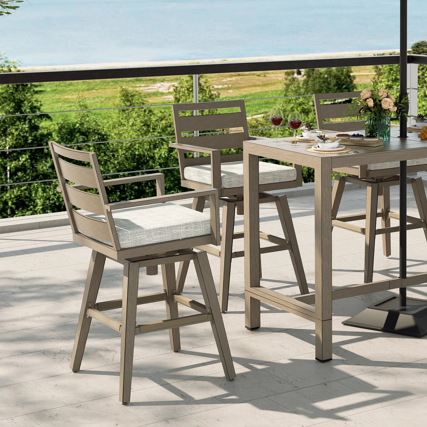 Outdoor dining set with high chairs and a table on a balcony with a view of greenery.