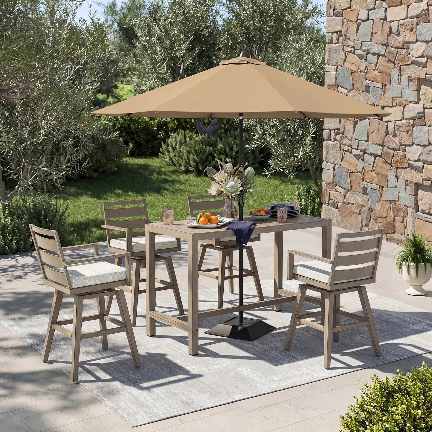 Outdoor patio set with table, chairs, and umbrella on a stone patio.