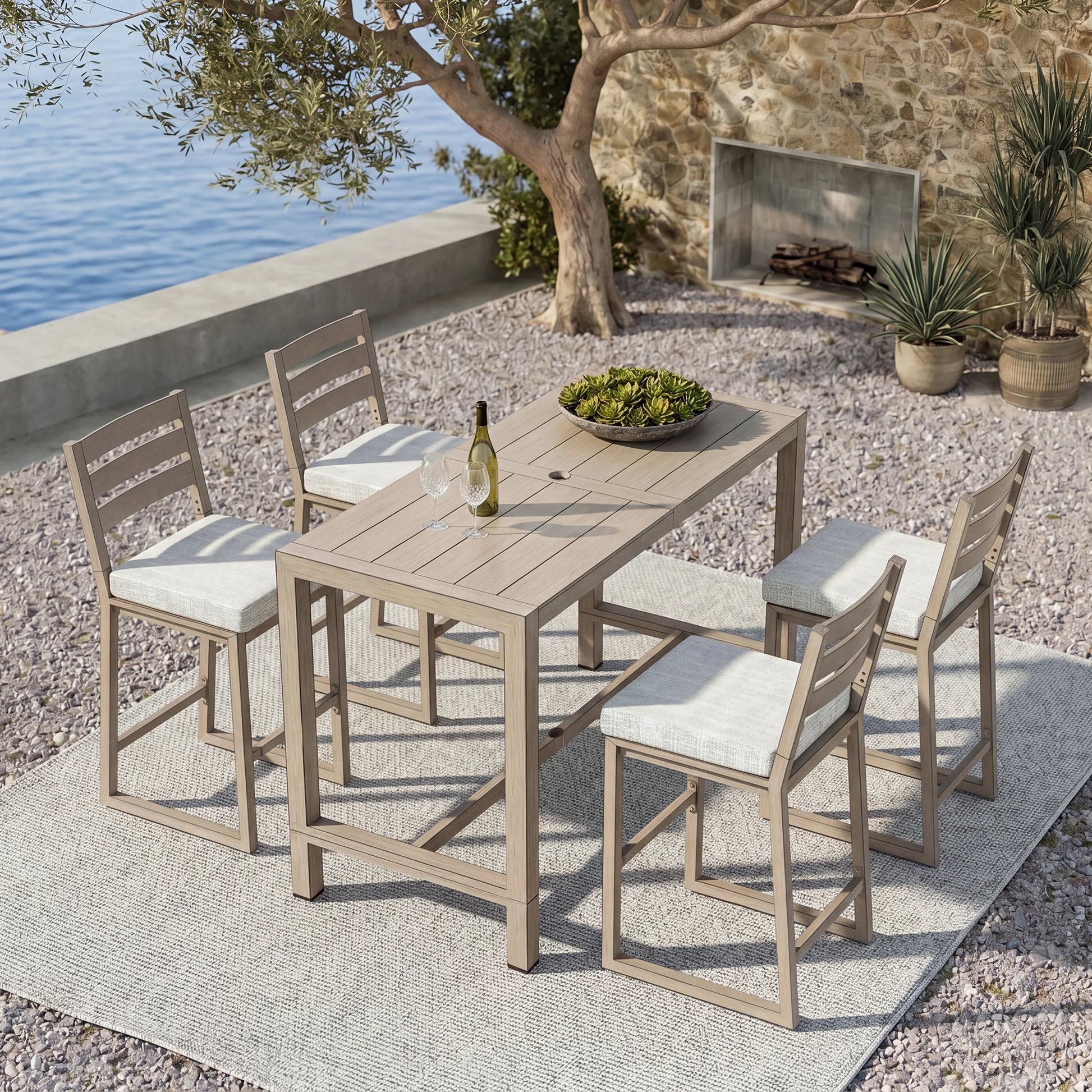 Outdoor bar set with bar table and stools by a waterfront.