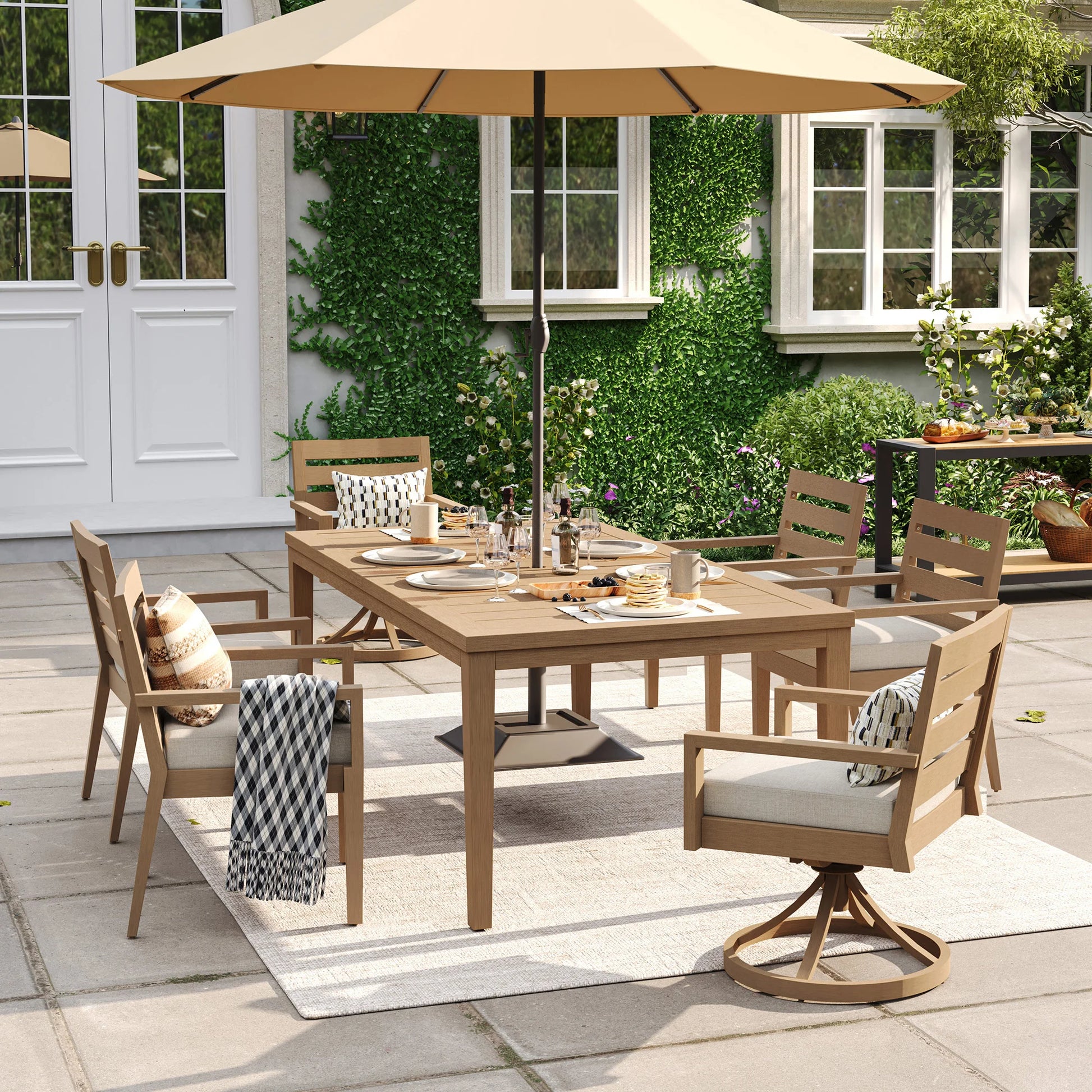 Alcudia 7-piece mixed seating patio set showcasing 4 stationary side chairs, 2 swivel rocker end-chairs, and a large beige market umbrella over the table.