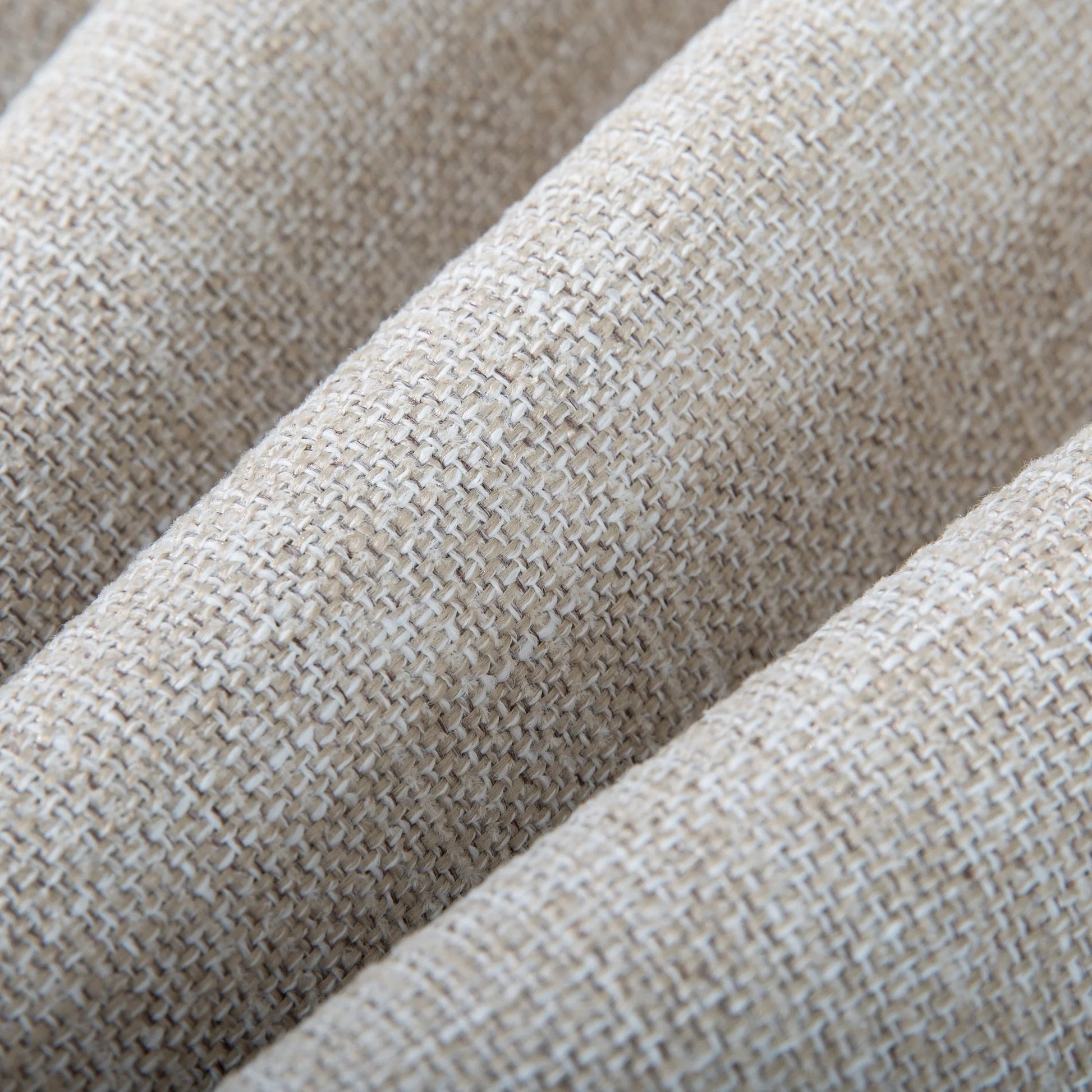 Macro close-up texture of the Alcudia patio chair cushion showcasing the high-quality woven texture of the beige solution-dyed spun polyester fabric.