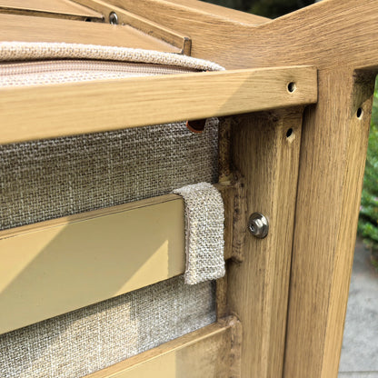 Under-seat close-up of the Alcudia patio chair showing the secure fabric fastener strap that keeps the non-slip woven cushion firmly attached to the wood-look aluminum frame.