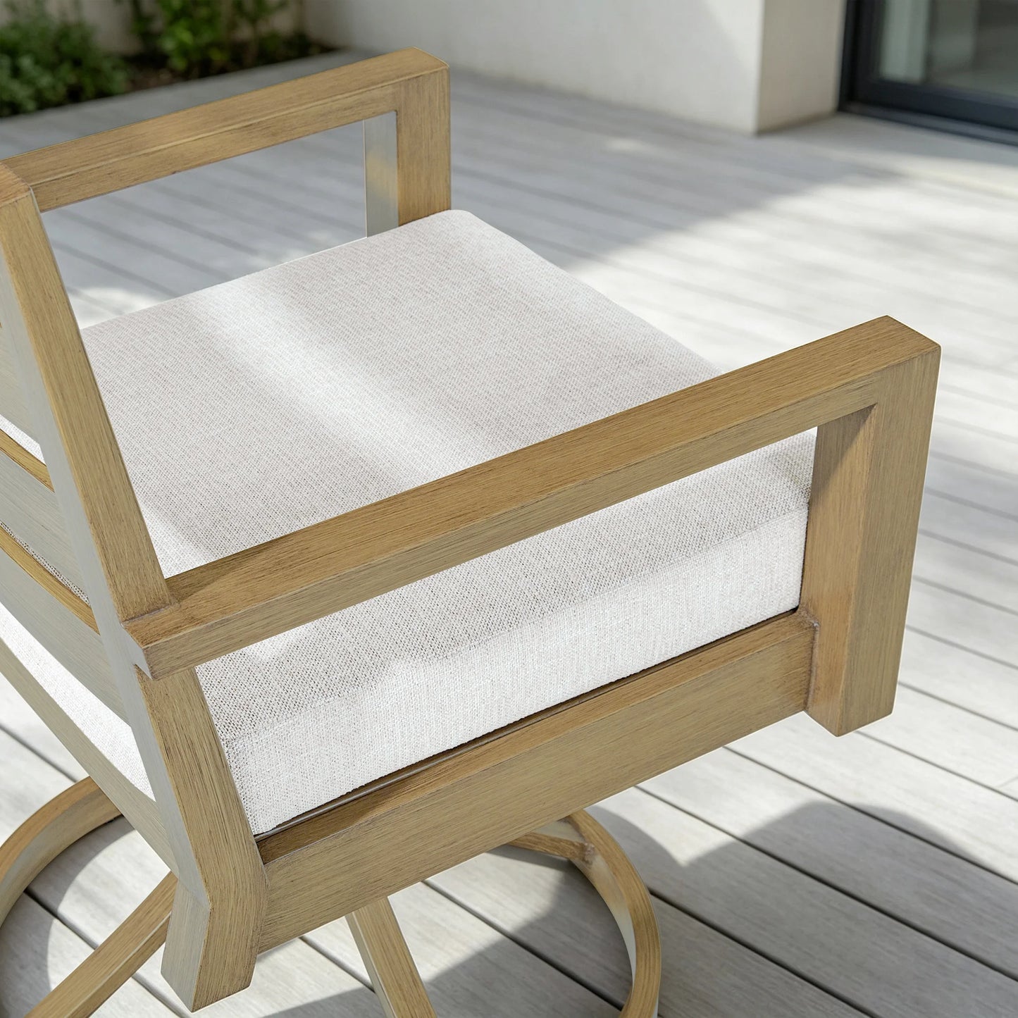 Top-down close-up view of the Alcudia patio dining chair focusing on the premium 3-inch thick woven fabric seat cushion and square armrests.