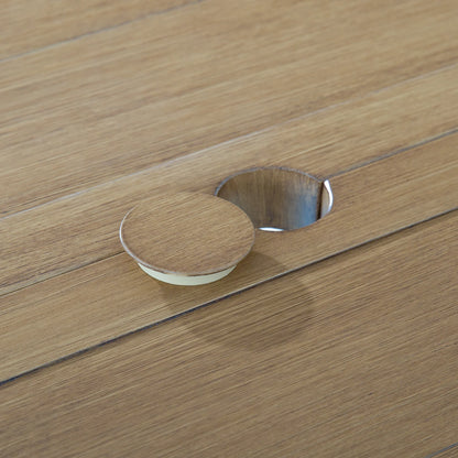 Detailed view of the integrated 1.96-inch umbrella hole with a matching removable hand-brushed wood grain cap on the Alcudia table.